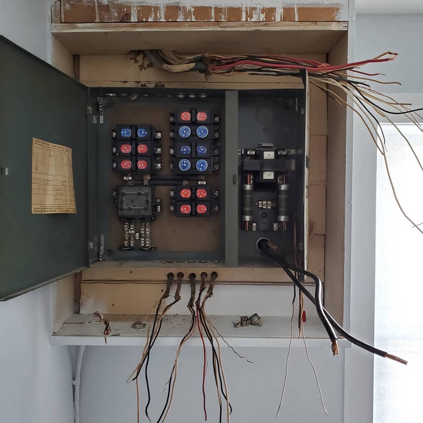 Open vintage fuse panel with damaged and disconnected wiring being diagnosed